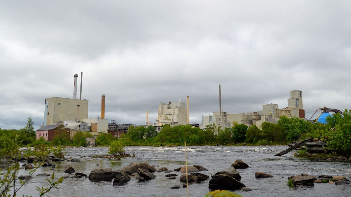 The Nine Papers mill seen from across a body of water.