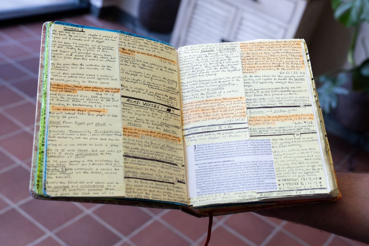 the inside of a bible filled with handwritten notes.