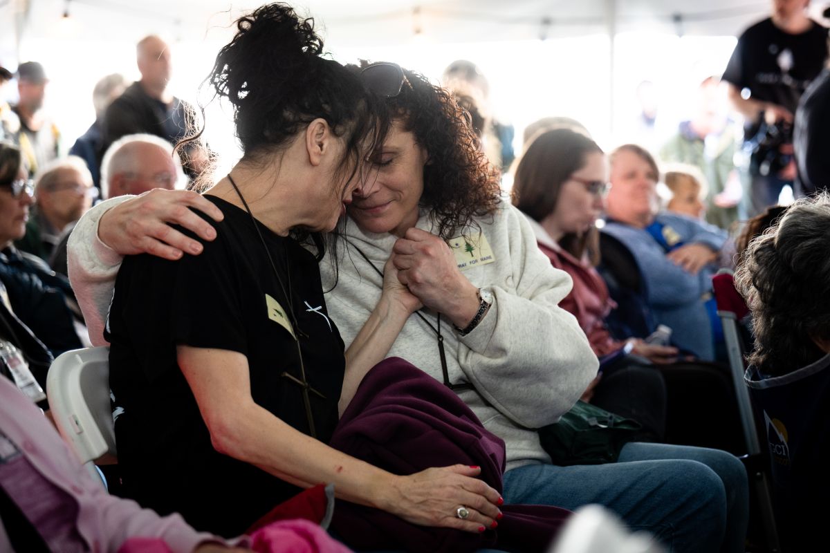 two event attendees embrace during the event