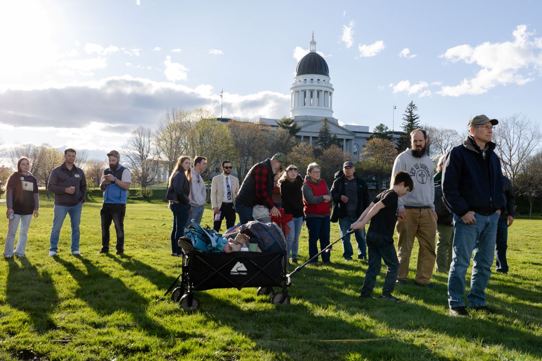 event attendees with the state house dome visible in the background