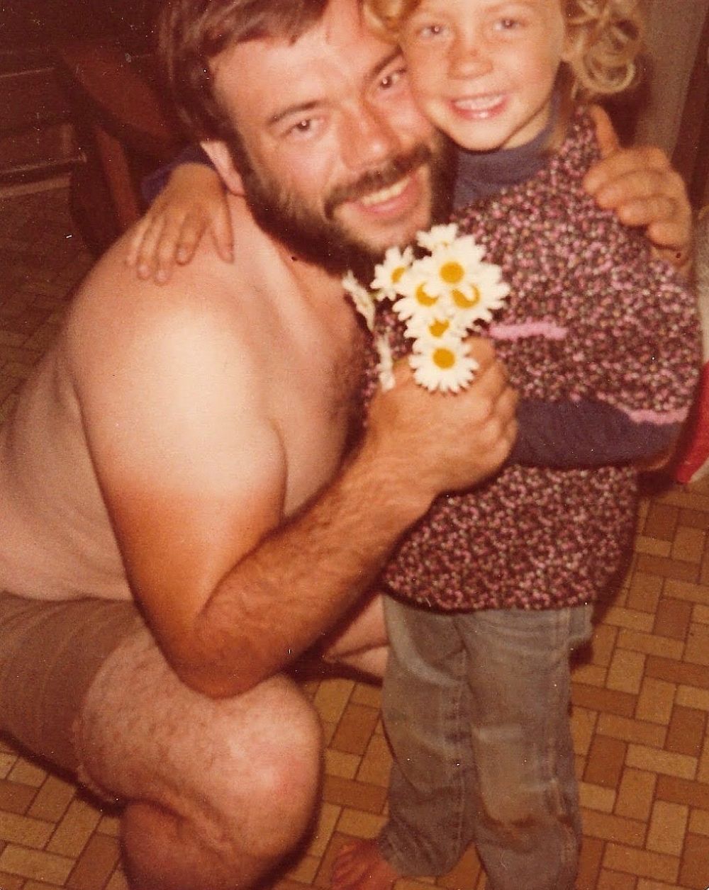 A photo of a younger Aimee and Fritz embracing and smiling for the camera. 