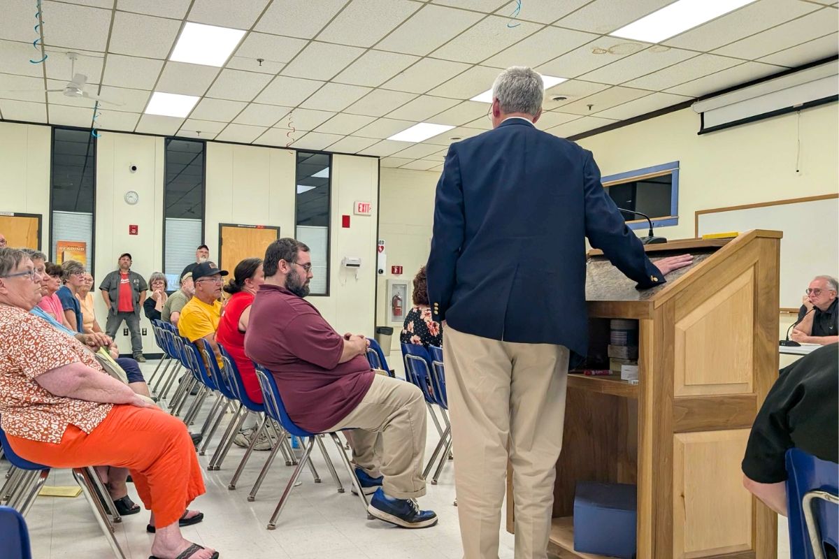 Andrew Hamilton addressing a crowd of residents.