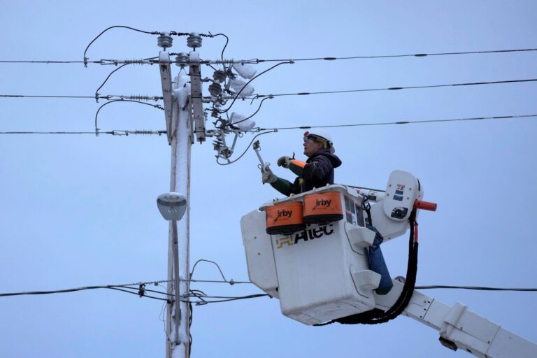 Central Maine Power lineman working to restore power.