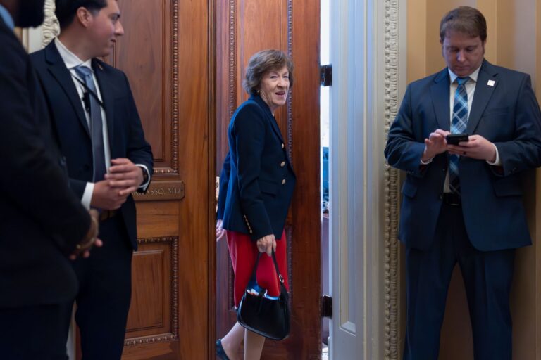 Susan Collins going through a door.