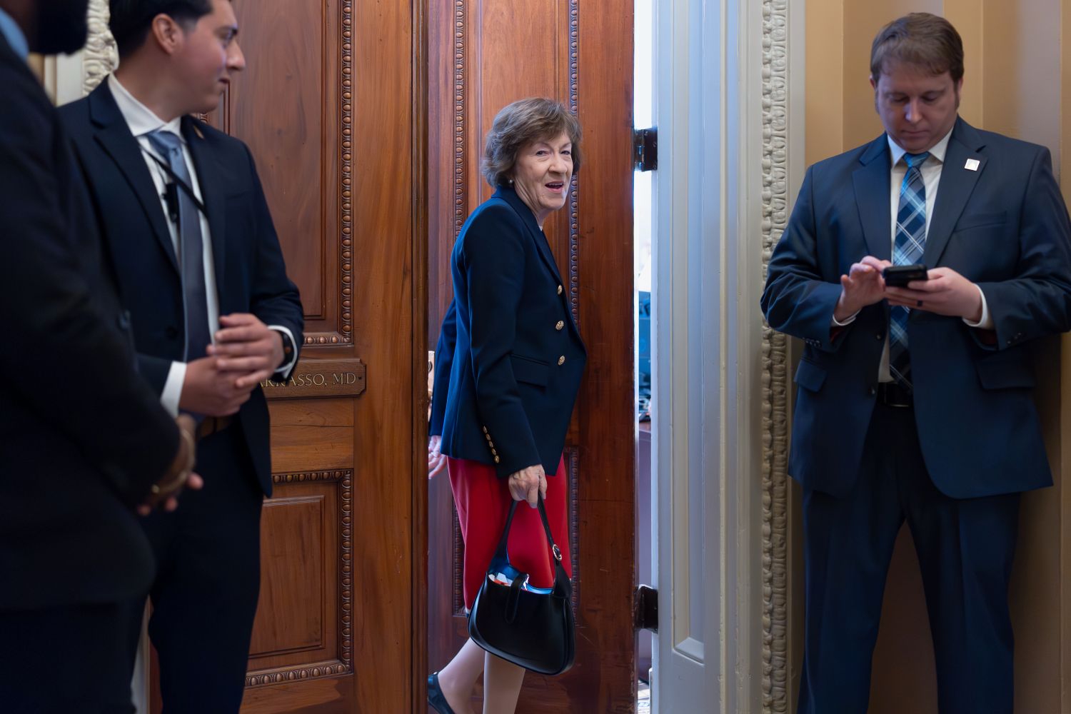 Susan Collins going through a door.