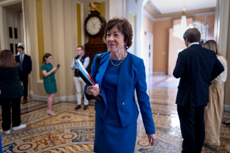 Susan Collins walking through the US Captiol.
