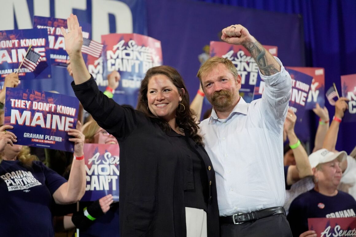 Amy Gertner and Graham Platner acknowledge a cheering crowd.