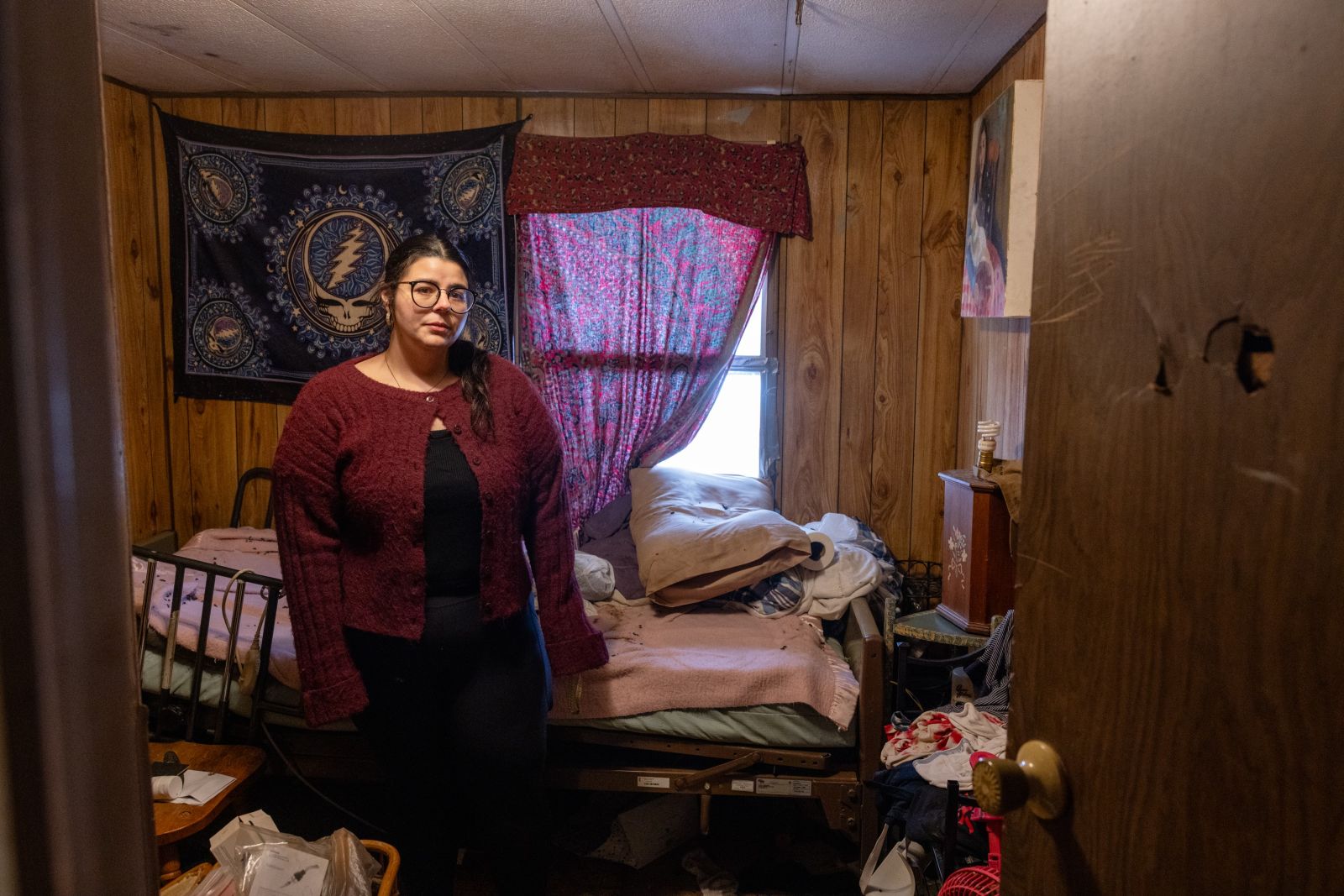 Christiana Lauzon stands in her father's bedroom.