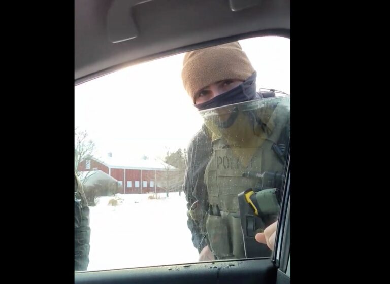 A screeshot from Peck's video shows an agent speaking to him through a car window.
