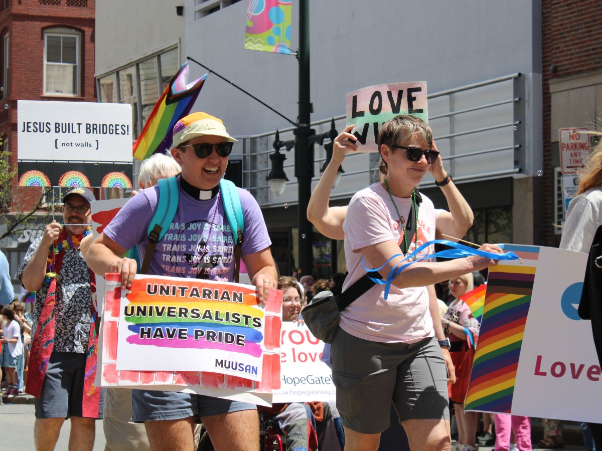 Rev. Tara Humphries marches in the Portland Pride parade while wearing a shirt that reads “Trans joy is sacred.” 