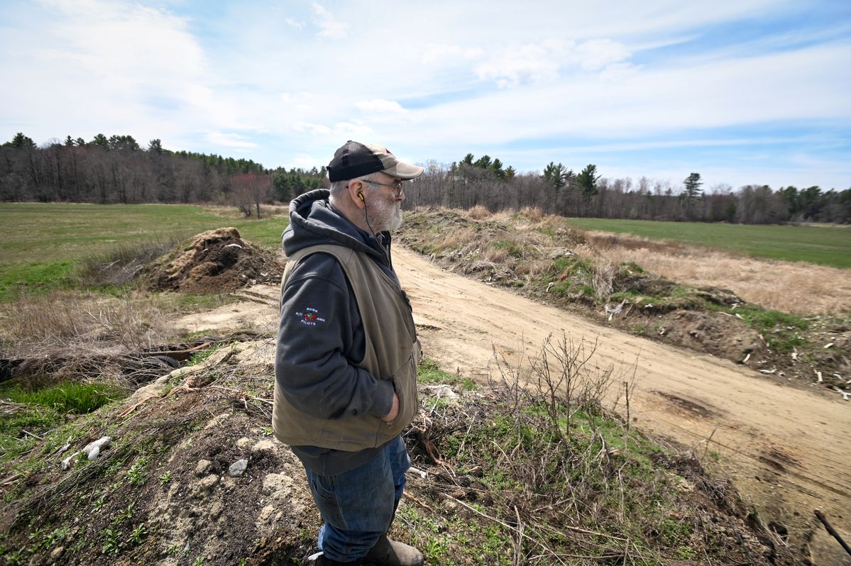 Fred Stone stands on his farm.