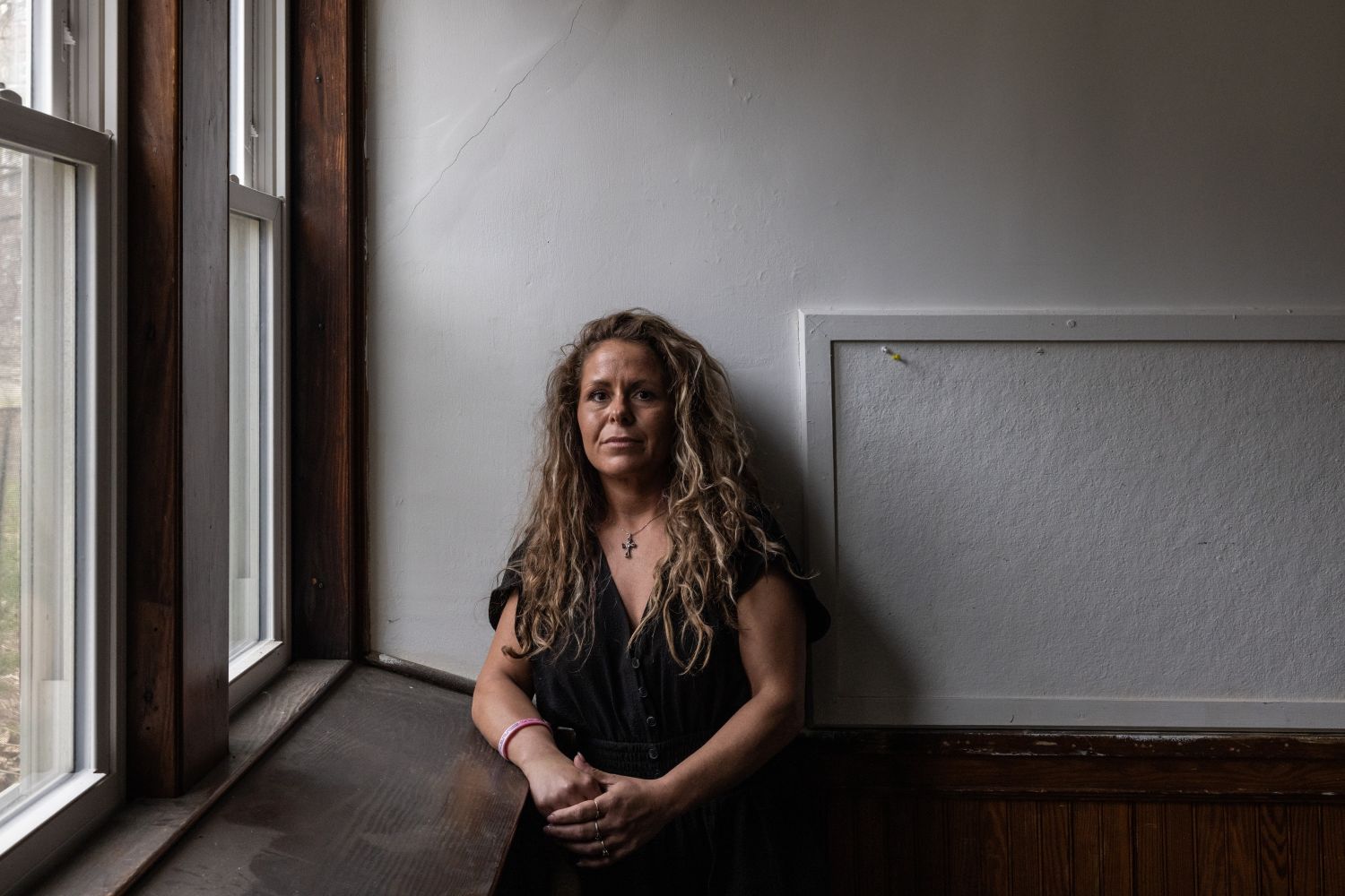 Audrey Condon poses for a photo while leaning against a wall.