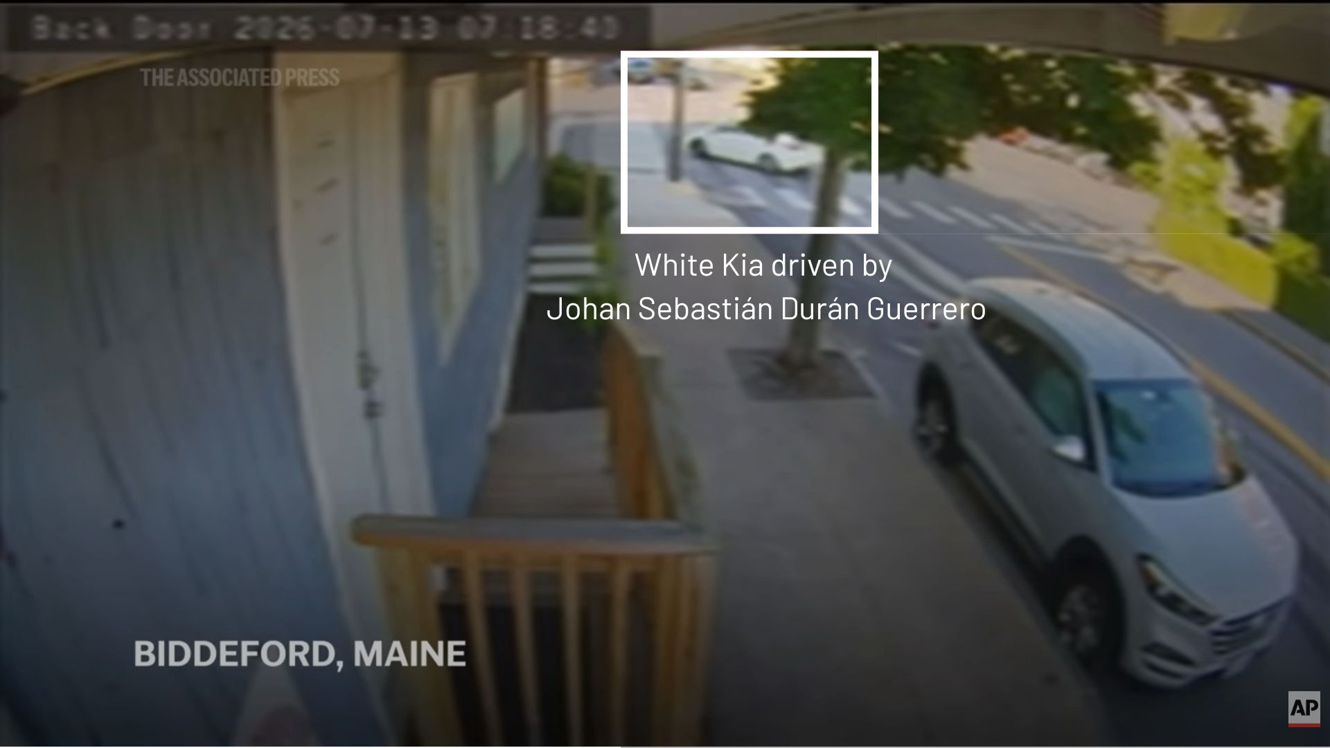 video still that shows a white kia.