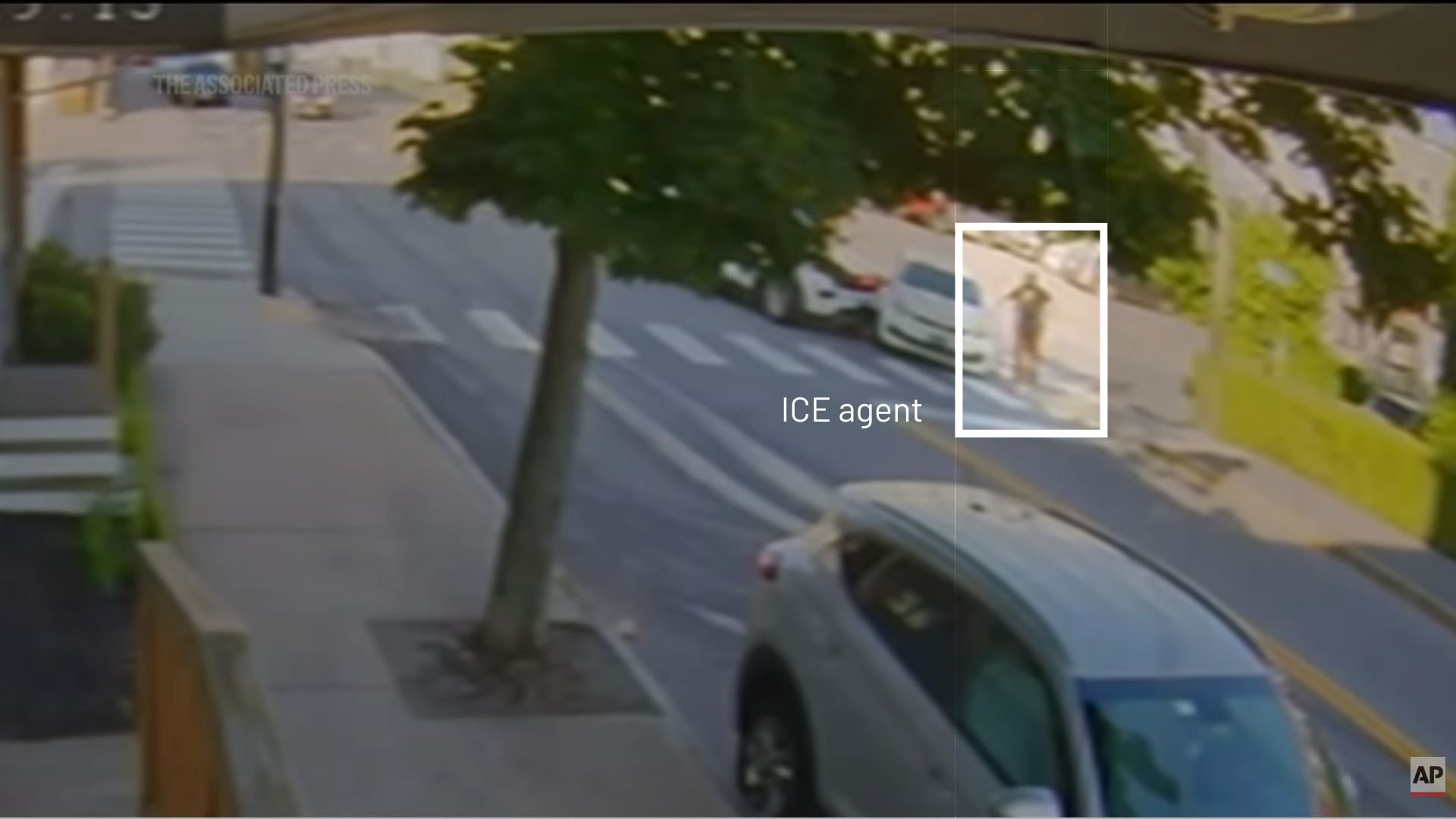 still from a video that shows where an ICE agent is standing in relation to vehicles involved.