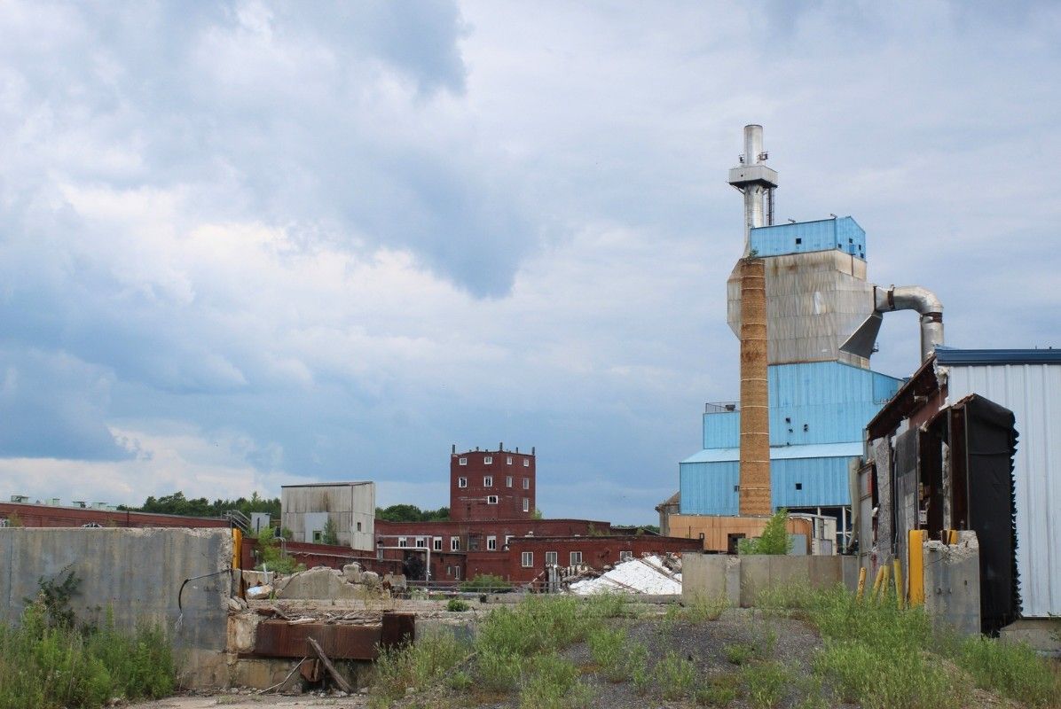 smokestack rising over the dilapidated buildings