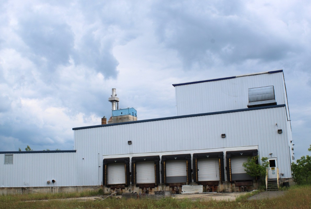 main smokestack of the former Lincoln Pulp and Tissue Mill rises behind Building 8