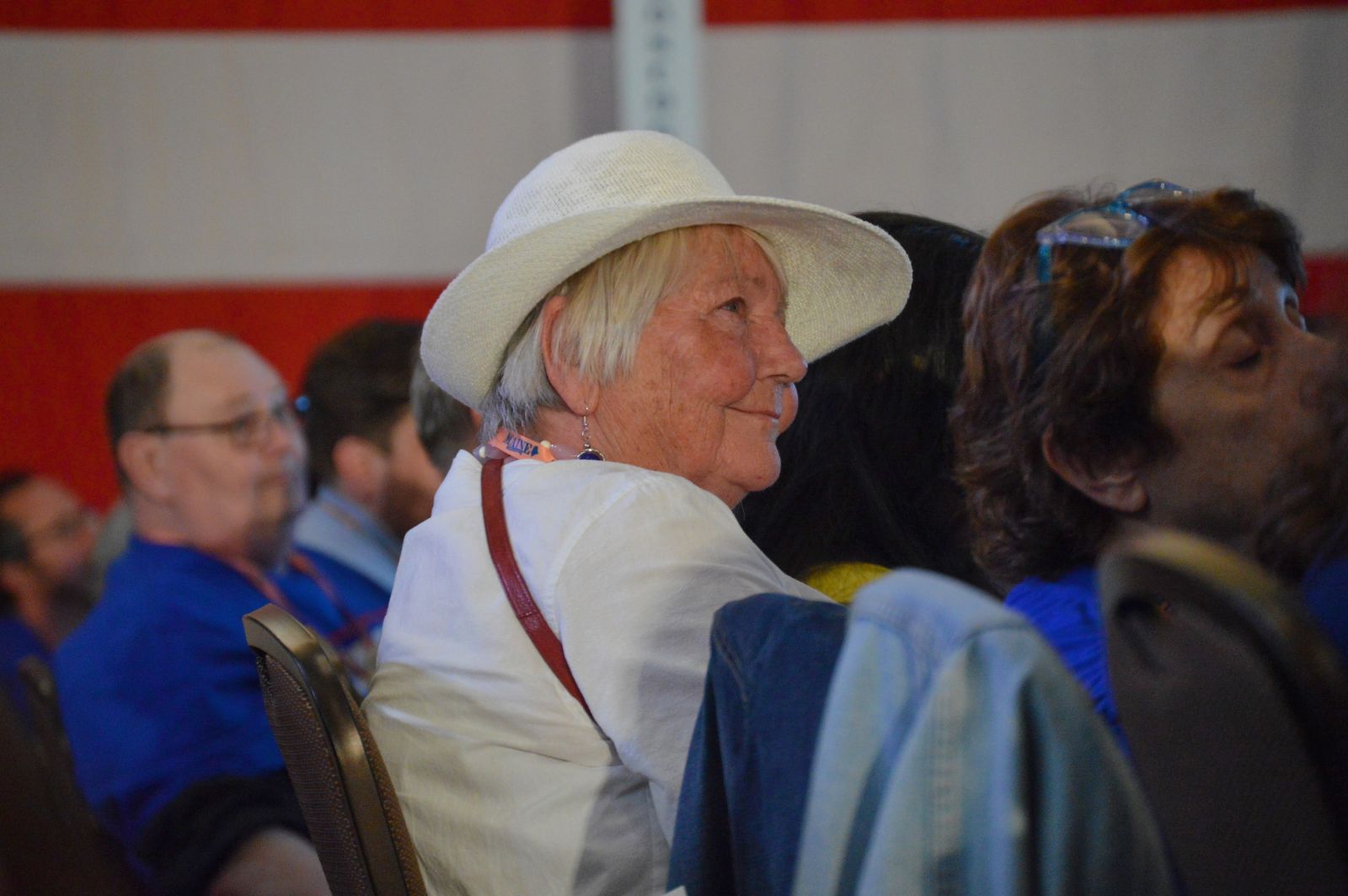 Joanne Twomey listens to a speaker while sitting in the crowd.