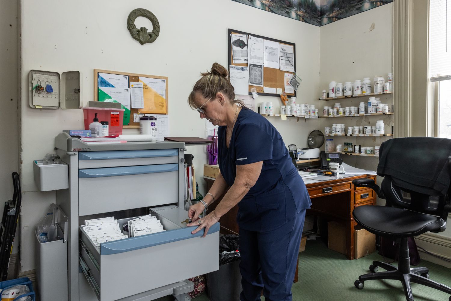 a woman opens a filing cabinet drawer