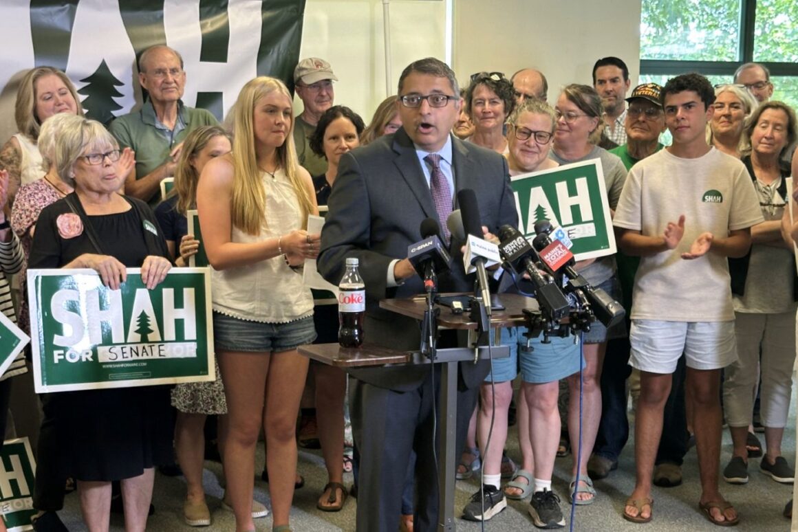 Nirav Shah speaks while standing at a podium during a press conference.