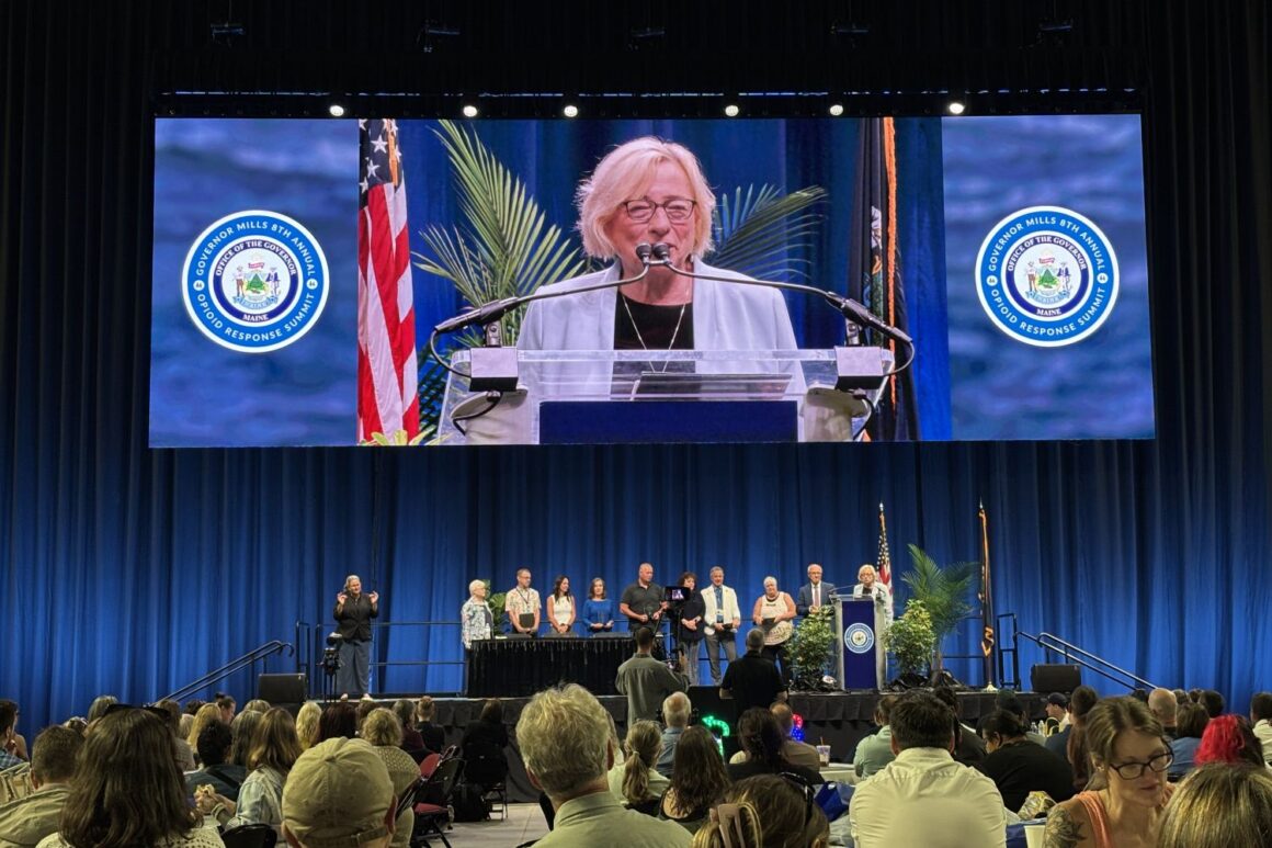 Governor Janet Mills speaking while standing at a podium.