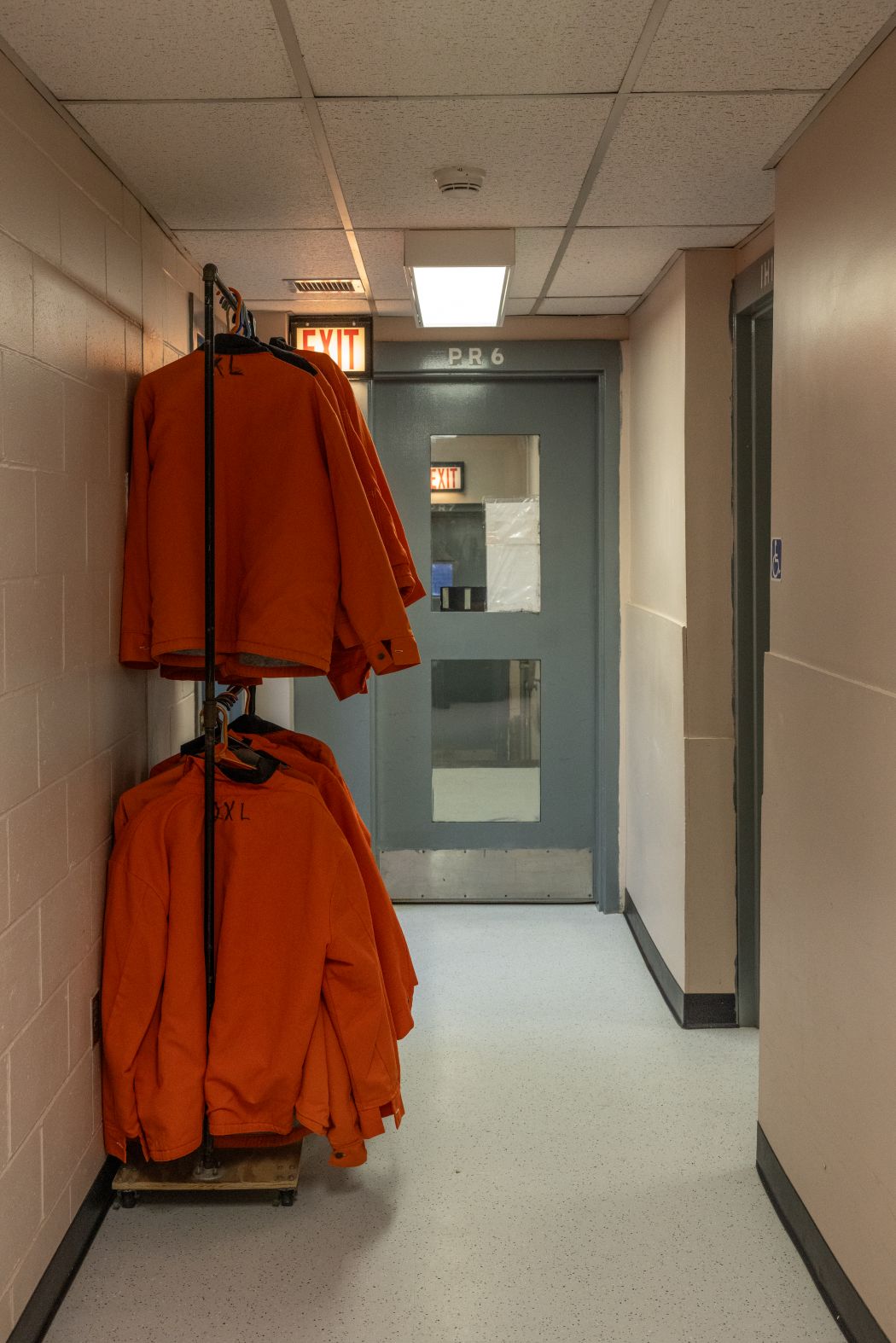 orange jail sweaters hang on racks