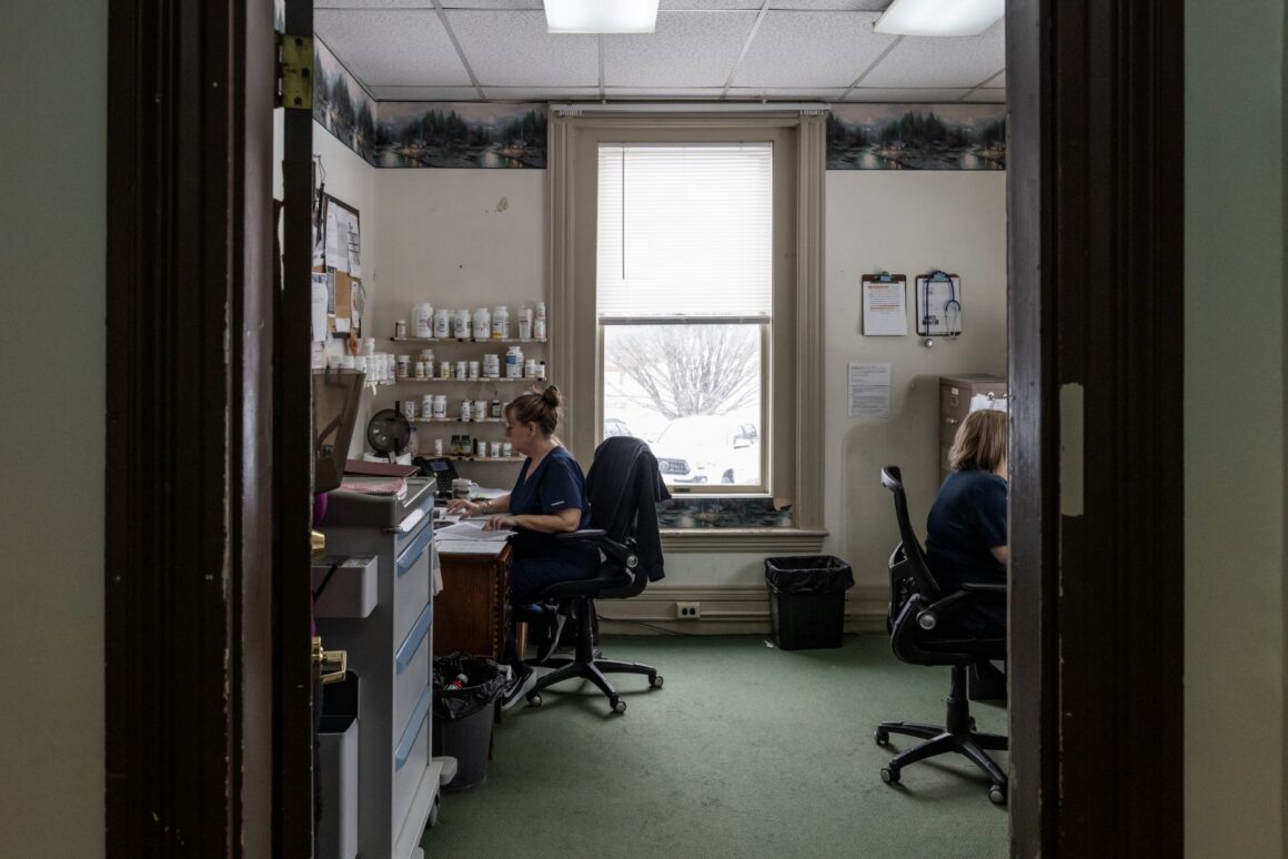 two women sitting at desks in an office.