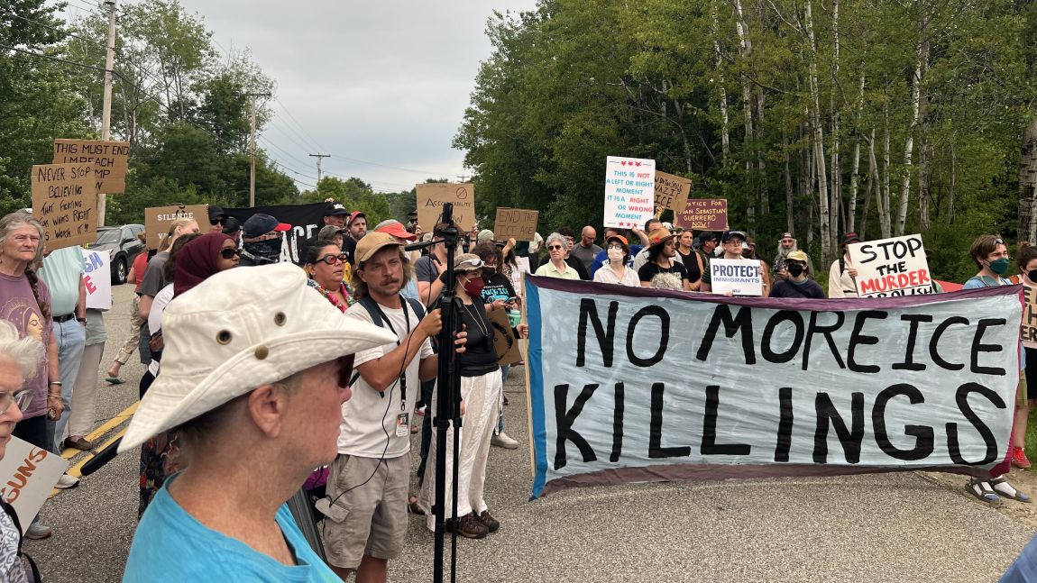 people holding a banner that reads no more ice killings.