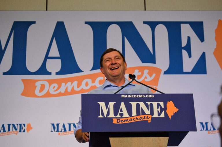Troy Jackson smiles while standing at the podium during the convention.