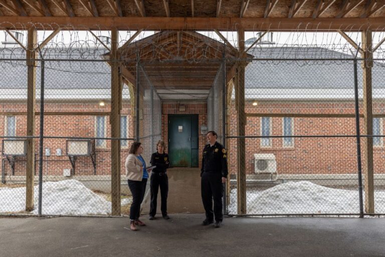 Emily Bader interviewing two corrections officers at the entrance of the piscataquis jail.