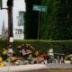 a man stands next to a makeshift memorial in biddeford