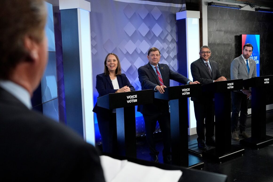 Shenna Bellows, Troy Jackson, Nirav Shah and Jordan Wood stand at debate podiums.