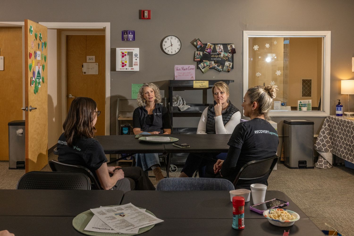 a group of franklin recovery center workers gather around a table