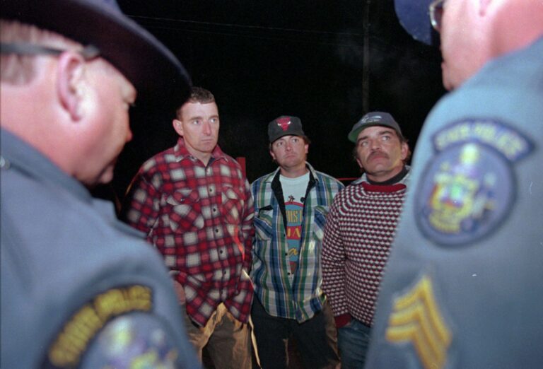 three young men speaking with two members of the maine state police.