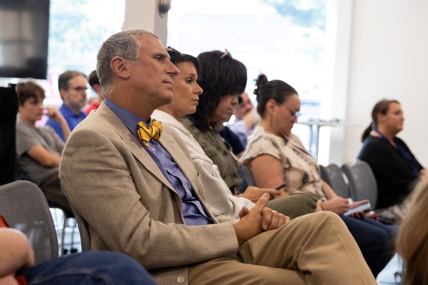 members of the audience listen to the panel discussion.