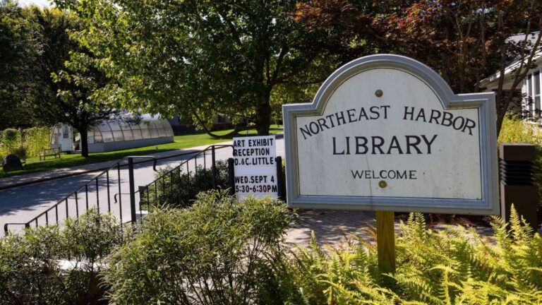 a sign at the entrance of the northeast harbor library