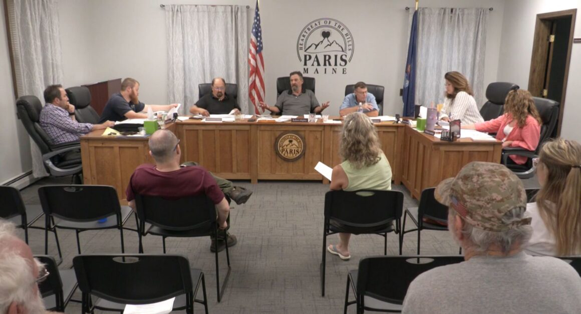 select board members sitting around a table.