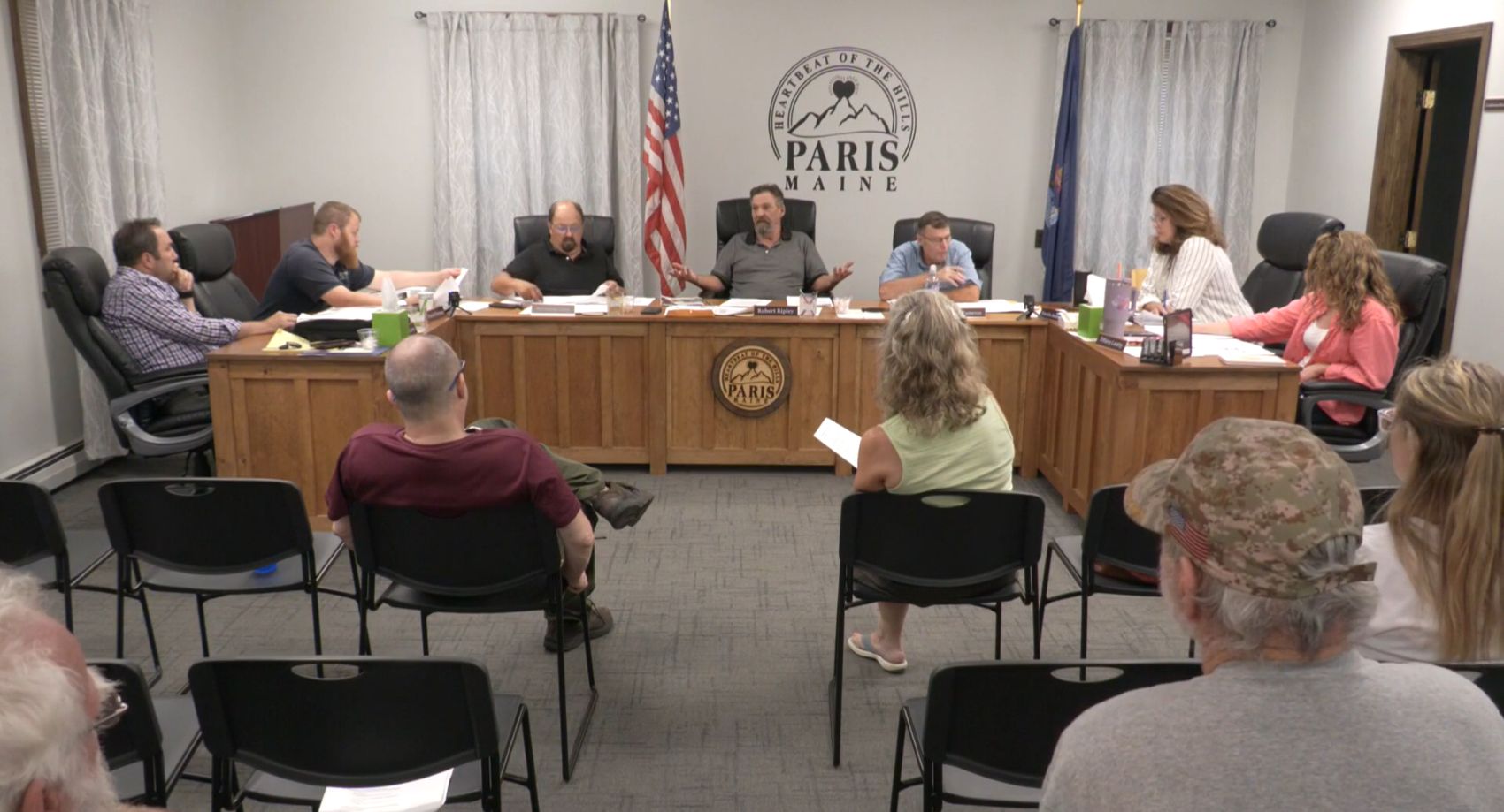 select board members sitting around a table.