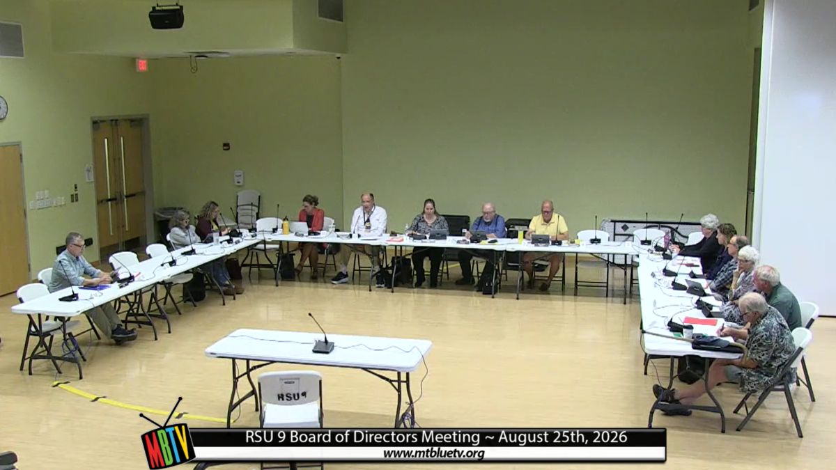 board members sit around a u-shaped table