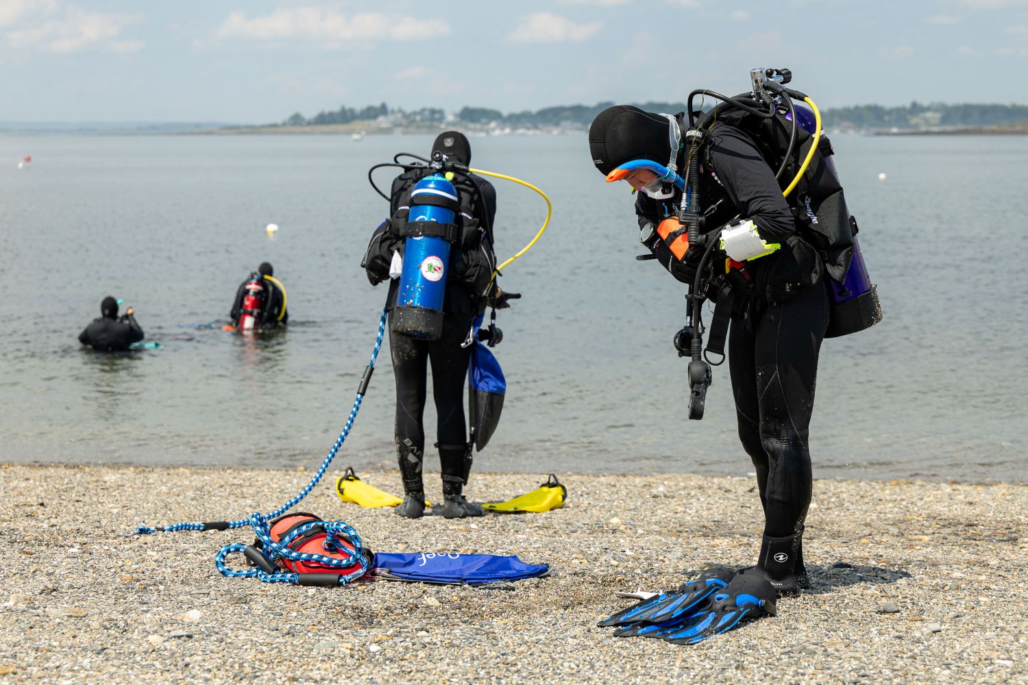 divers prepare to enter the water