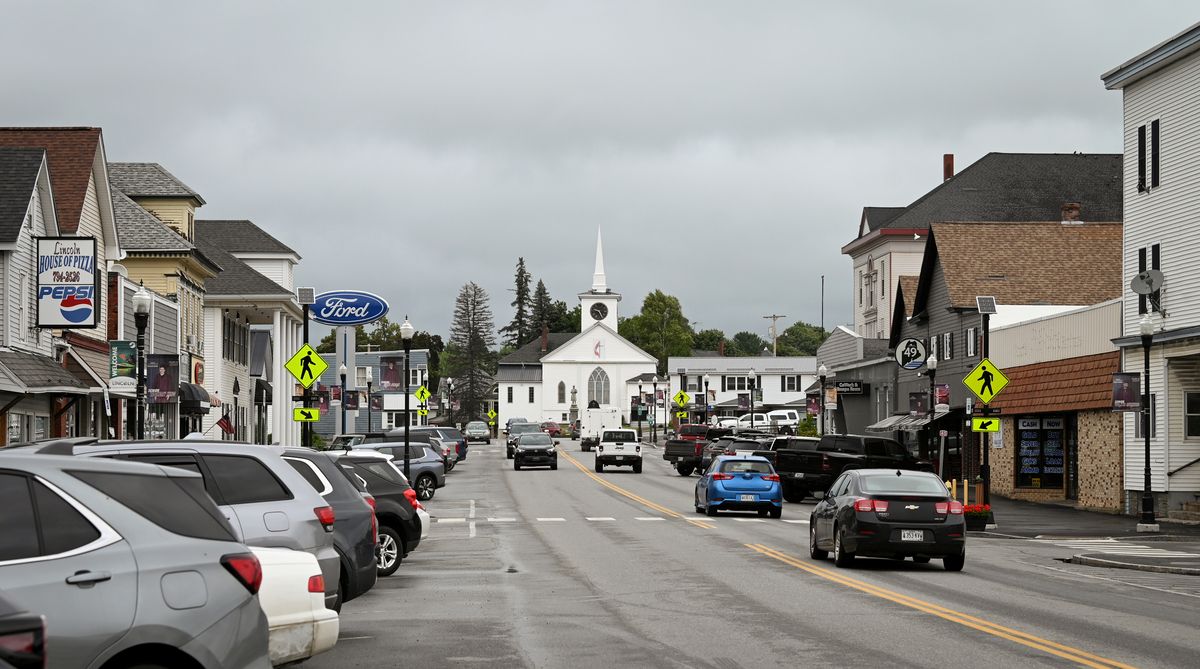 a street lined with businesses and cars