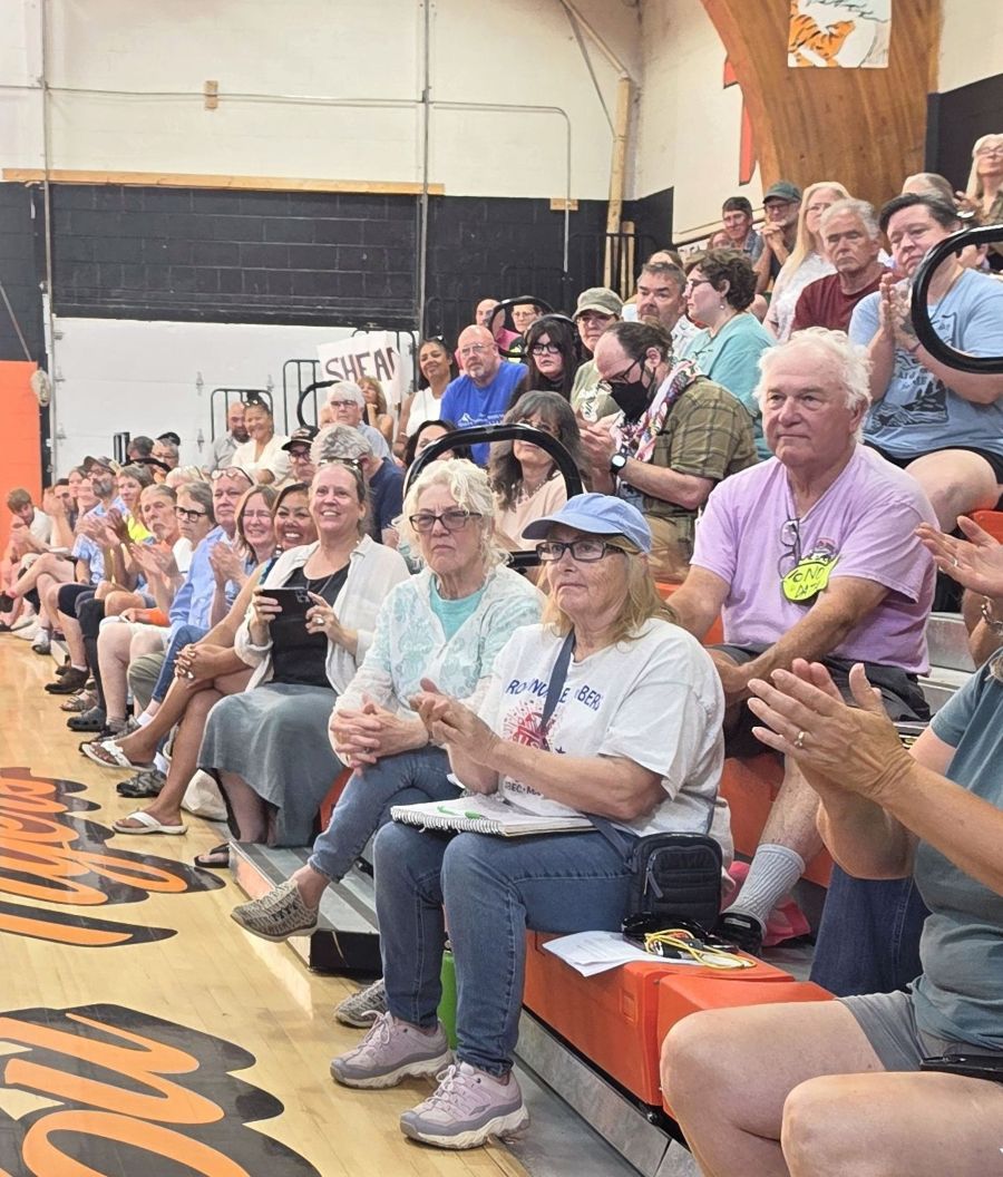 hearing attendees applaud a speaker