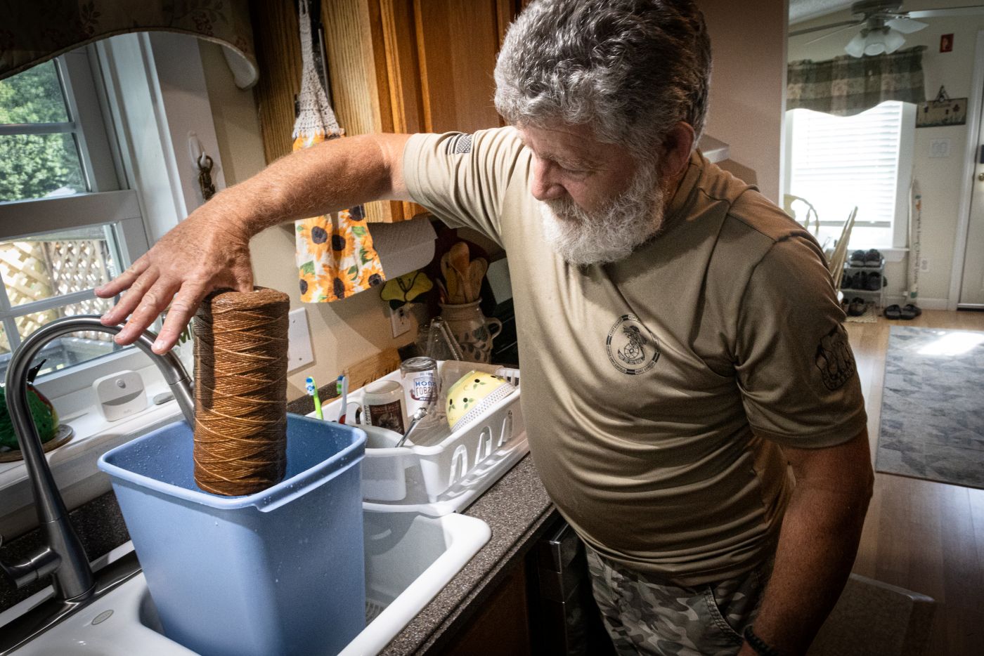 a man lifts a brown filter