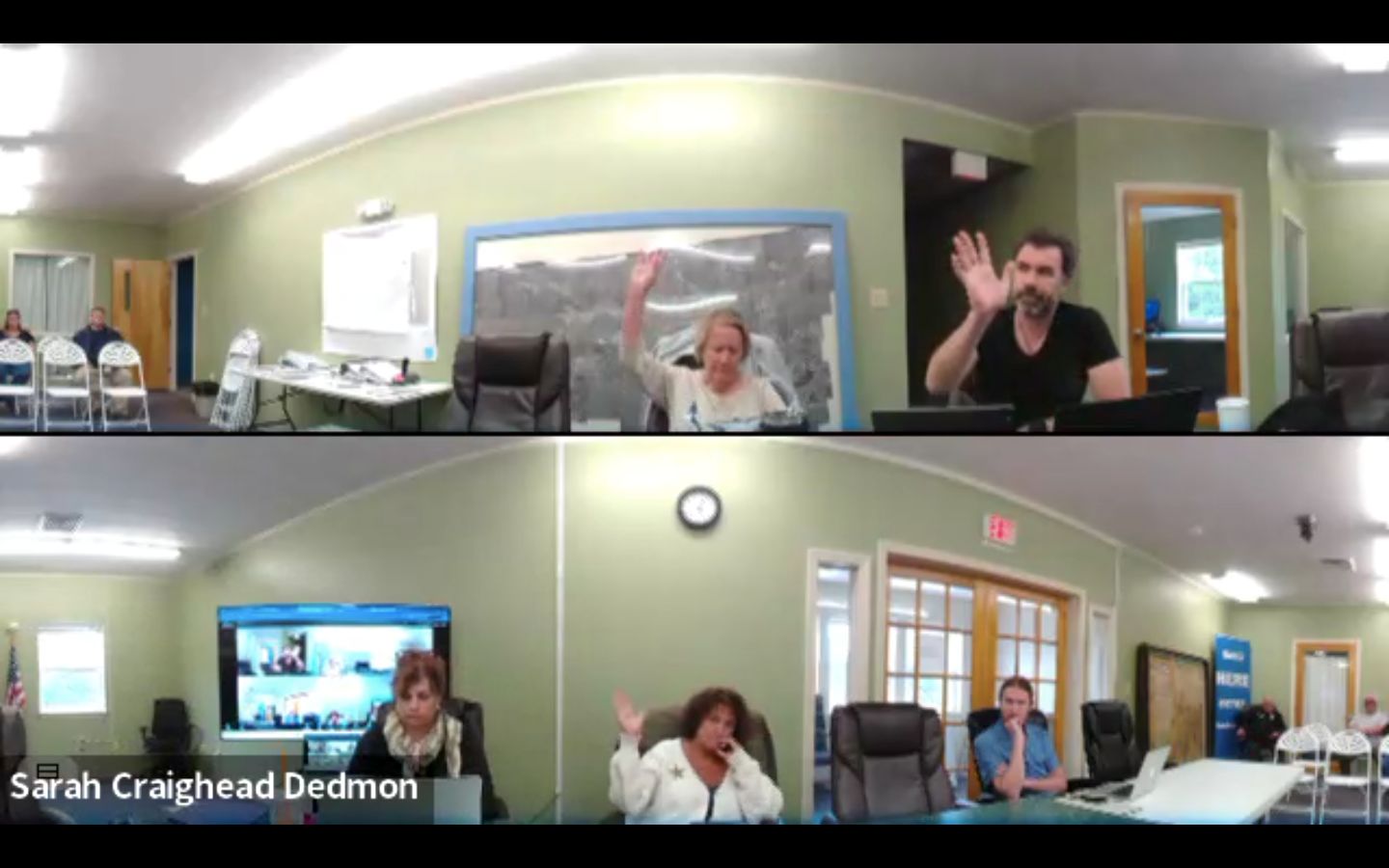 members of the machias select board cast votes during a meeting.
