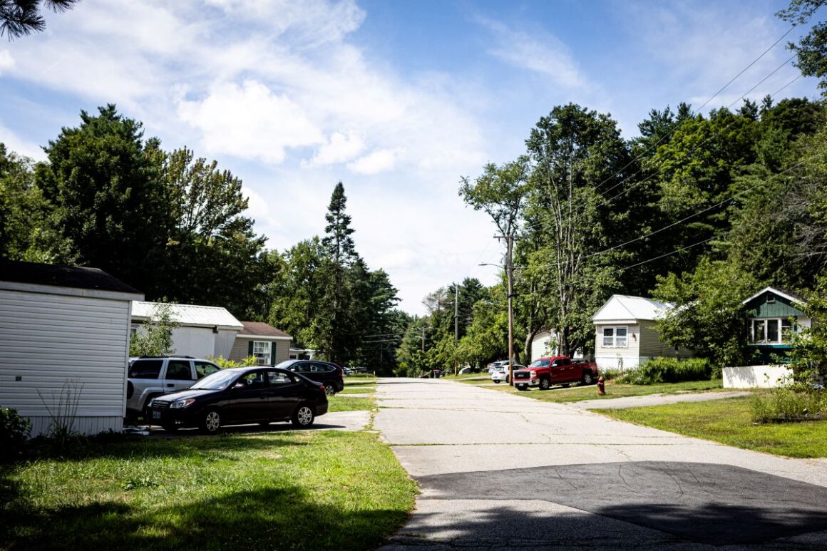 mobile homes line both sides of a road.