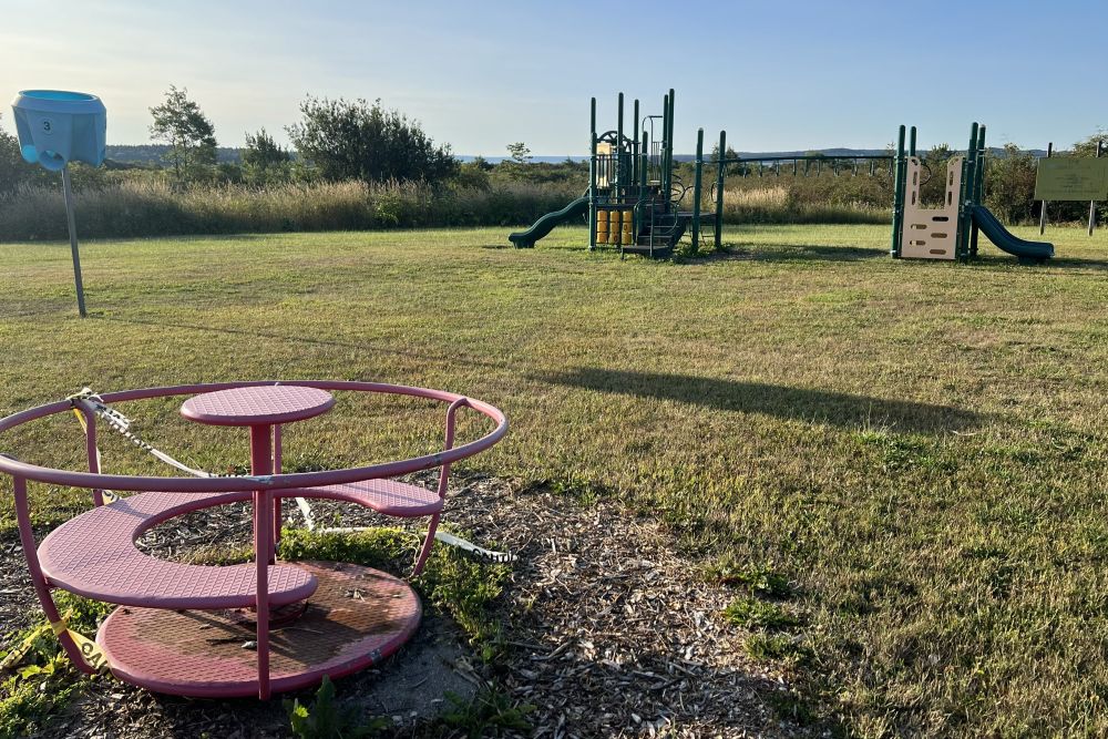 worn down playground in the back of the school.