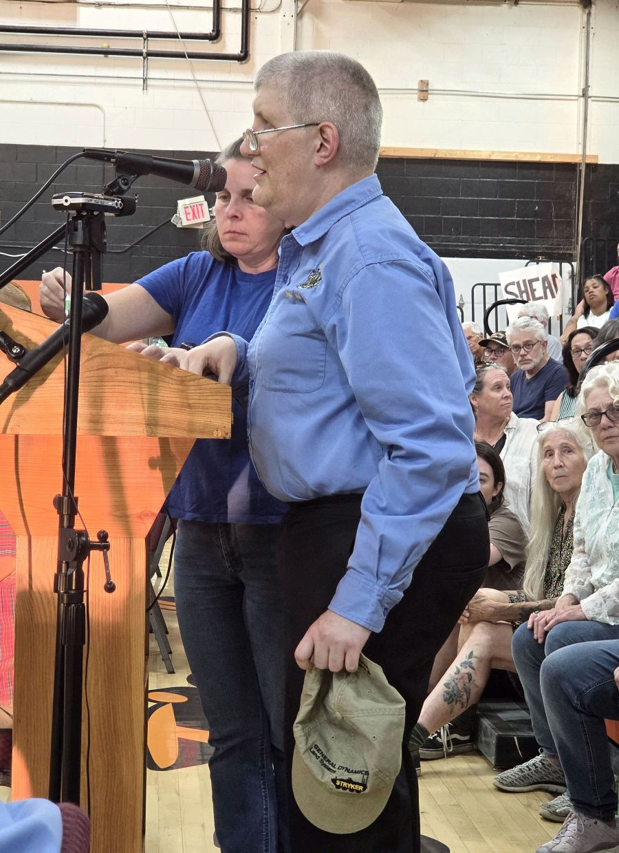 Rep. William Tuell speaking at a podium.
