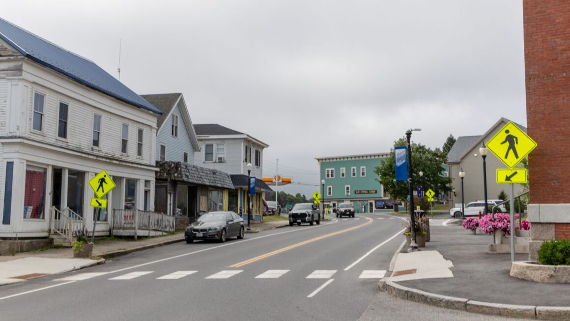 buildings line both sides of the road in downtown machias