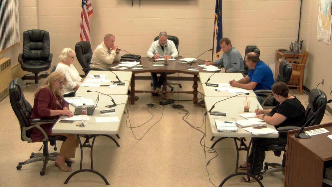 members of the council sit around a u-shaped table