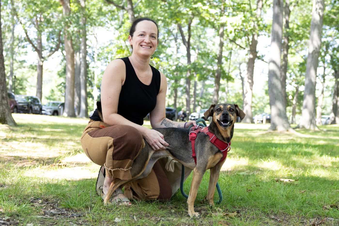 a woman poses for a photo with her dog