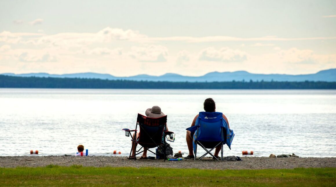 people sitting in chairs at a beach